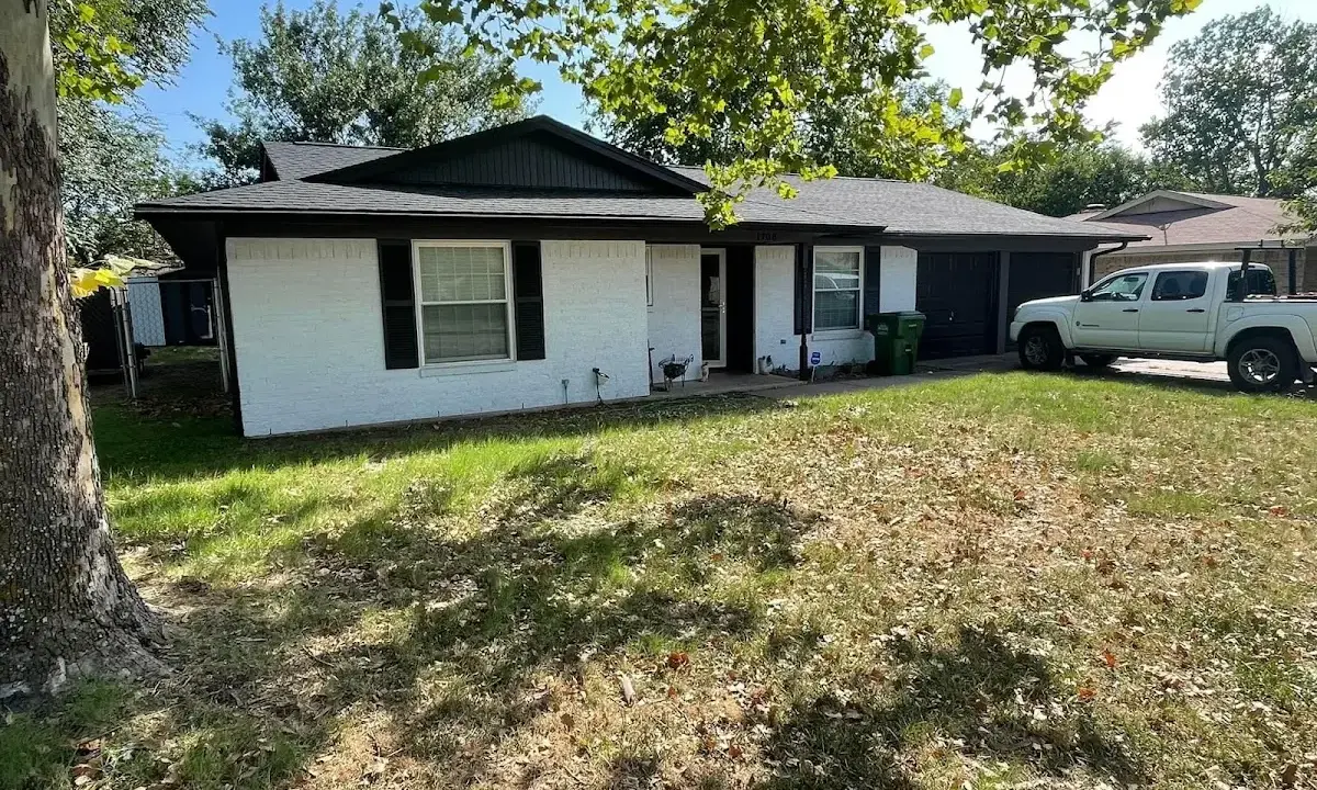 Professional roofing crew working on a residential roof in Kingsland